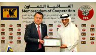 Qatar Football Association (QFA) President Sheikh Hamad bin Khalifa bin Ahmed Al Thani (right) and Japan Football Association (JFA) President Kohzo Tashima pose for a photograph during the cooperation agreement signing ceremony at Al Bidda Tower yesterday