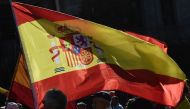 People wave a Spanish flag during a demonstration calling for unity in Madrid on October 28, 2017, a day after direct control was imposed on Catalonia over a bid to break away from Spain.   AFP / JAVIER SORIANO
