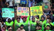 Spectators hold placards during the Twenty20 international between Pakistan and Sri Lanka in Lahore, yesterday. 