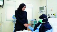 Minister of Public Health H E Dr Hanan Mohamed Al Kuwari visiting a stem cell transplant patient.