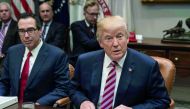US President Donald Trump speaks at a meeting with business leaders on tax reform at the White House in Washington, DC, on October 31, 2017. On left, is Treasury Secretary Steve Mnuchin. AFP / Nicholas Kamm
