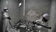 This photograph taken on October 19, 2017 shows Fragment Room employees smashing bottles during a demonstration in a 