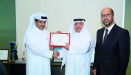 Ahmed Al Henzab (left), Head of Administration and Properties, Doha Bank;  handing over the aid to Saad Shaheen Al Kaabi (centre), Director of Resource Mobilisation Department; and Hamid Moharrar, Head of Corporate Relations at QRCS. 

