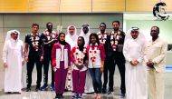 Cherif Younousse and Ahmed Tijan, members of Qatar A team which won the men’s beach volleyball team at the 26th Arab Championship in  Oman, pose for a picture with officials of Qatar Volleyball Associating in Doha on Thursday.
