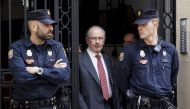 Former International Monetary Fund chief Rodrigo Rato (C) walks between police officers as he leaves his office in Madrid April 17, 2015. REUTERS/Andrea Comas
