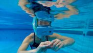 A therapist tests out new cutting-edge waterproof virtual reality glasses playing a film of dolphins, at the 'S Heeren Loo care centre for disabled people in Apeldoorn, on October 31, 2017, eastern Netherlands. AFP / JOHN THYS