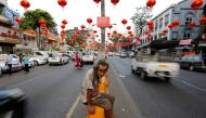 A man sits under lanterns and decorations on a street ahead of the Chinese Lunar New Year in Chinatown, Yangon, January 23, 2017. (Reuters / Soe Zeya Tun) 