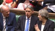A video grab from footage broadcast by the UK Parliament's Parliamentary Recording Unit (PRU) shows Britain's Chancellor of the Exchequer Philip Hammond (C) with Britain's Prime Minister Theresa May (R) and Britain's Transport Secretary Chris Grayling (L)