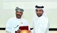 A member of the Omani delegation honours the President of QU, Dr Hassan Al Derham.