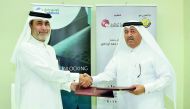 Hussain Yousef Al Abdul Ghani (right), Head of Administrative and Financial Affairs, Qatar Chamber; and Ibrahim Jassem Fakhri, Qatalum’s Communications Manager; shake hands after signing the sponsorship agreement at Qatar Chamber headquarters, yesterday.