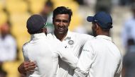 Indian cricketer Ravichandran Ashwin (C) celebrates with captain Virat Kohli (L) after India won the second Test cricket match against Sri Lanka at the Vidarbha Cricket Association Stadium in Nagpur on November 27, 2017. / GETTYOUT/ AFP / PUNIT PARANJPE /