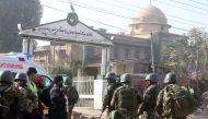 Pakistani security forces and rescuers are seen outside Peshawar Agricultural Training Institute which was attacked by Taliban militants, in the northwestern city of Peshawar, in Khyber Pakhtunkhwa province, Pakistan, on December 1, 2017.  Muhammad Asad -