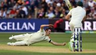England paceman Craig Overton (L) dives in an attempt to take a catch from Australia's batsman Steve Smith (R) on the first day of the second Ashes cricket Test match in Adelaide in December 2, 2017. (AFP / WILLIAM WEST)