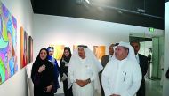 Ahmed Al Sayed, Deputy Director General of Operations at Katara, Dr. Mohamed Abdel Rahman Al Sayed, international representative of disability and other officials visiting paintings by artist Dania Tariq at the Cultural Village Foundation-Katara Building 