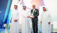 Arnab Mukherjee (second right), Vodafone Qatar’s Business Continuity Manager receiving an award on behalf Vodafone Qatar from H E Dr Mohammed bin Saleh Al Sada (second left), Minister of  Energy and Industry, as Sheikh Faisal bin Qassim Al Thani (right) ,