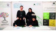 Machaille Al Naimi, President of Community Development, QF, and Fatima Al Sulaiti, Chair, QAFA, at the agreement signing ceremony. Also present was Sultana Afdhal, Acting CEO, WISH.