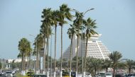 Palm trees on the  divider of the Corniche road swaying in the strong wind. January 5, 2016. Salim Matramkot © The Peninsula