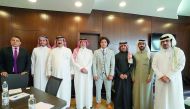 Hassouna (fifth left) poses for a photograph with the President of QFWF, Mohamed Yousef Al Mana and other officials.