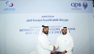 Rashid bin Ali Al Mansoori (left), CEO, Qatar Stock Exchange shakes hand with Abdulaziz Al Khalifa, CEO of Qatar Development Bank, after signing the agreement.