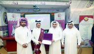 Minister of Education and Higher Education H E Dr Mohammed Abdul Wahed Ali Al Hammadi with  student Abdullah Khaled Al Kaabi in the presence of his guardian and the head of the school.