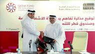 Khalifa bin Jassim Al Kuwari, the Director General of Qatar Fund for Development, and Dr. Eng. Saad bin Ahmad Al Muhannadi, President of ‘Ashghal’ during the ceremony held at Ashghal’s building yesterday. Pic: Abdul Basit / The Peninsula