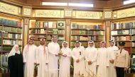 H E Dr Hamad bin Abdulaziz Al Kawari with cadets and teachers at his library.