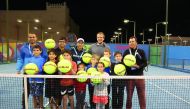 Bosnian tennis player Mirza Basic poses  for a photograph with young participants at the annual kids tennis clinic co-hosted by ExxonMobil Qatar and Qatar Tennis Federation yesterday.