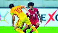 Akram Afif of Qatar attempts to break through Chinese defence during their FIFA World Cup 2018 qualifier which took place at the Khalifa International Stadium in Doha in this September 2017 file photo.