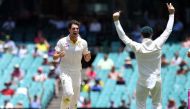 Australia's Pat Cummins (L) celebrates with captain Steve Smith (R) after dismissing England batsman Stuart Broad on the final day of the fifth Ashes cricket Test match at the SCG in Sydney on January 8, 2018. / AFP.