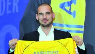Dutch star Wesley Sneijder poses with his new Al Gharafa jersey at his unveiling for the QSL club yesterday.  Picture by Kammutty VP/The Peninsula