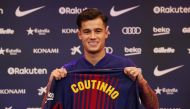 FC Barcelona's new signing Philippe Coutinho poses with the club shirt REUTERS/Albert Gea
