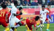 Qatari striker Almoez Ali carries the ball as he celebrates with team-mates  Ahmad Moein (centre) and  Hashim Ali (right) after scoring his first goal against China during their AFC U-23 Asian Cup match played in Changzhou, China yesterday.