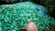 A woman sorts out recyclable plastic soft drink bottles at Xa Cau Village, outside Hanoi, Vietnam. Reuters/Kham