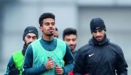 Qatari star Akram Afif (foreground) and team-mates train ahead of quarter-final clash against Palestine yesterday.
