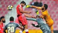 Al Duhail  goalkeeper Lecoumet Kloud punches the ball to safety during their QNB Stars League match against Al Arabi at Al Arabi Stadium in Doha yesterday.  Pic: Baher Amin/The Peninsula