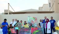 Patients and healthcare professionals with the artwork illustrated during the ‘Qatar Cares’ event to be displayed at the Bayt Aman residential villa in Al Thumama.