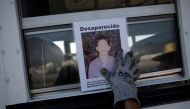 A woman holds the photograph of a relative lost in fight between drug gangs during a serach at Escobedo on the outskirts of Monterrey, Mexico, August 12, 2016. (Reuters) 
