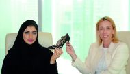 Qatari designer, Hissa Haddad (left), and Italian Chamber Chairperson, Palma Libotte, hold a gold-and-pearl-studded designer shoe during a press conference at Marriott Marquis Hotel in Doha yesterday. Pic: Salim Matramkot / The Peninsula
