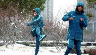 Qatar’s players share light moment in snow on the eve of their third place play-off in Kunshan, China yesterday.