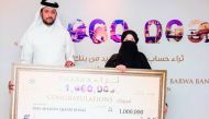 Khalid Al Subeai, Group Chief Executive Officer at Barwa Bank, with QR1m prize winner Amal Ghalayini.