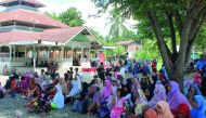 Families of orphans in Indonesia waiting to receive Qatar Charity’s aid. 