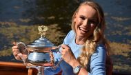 Denmark's Caroline Wozniacki arrives in a gondola with the winner's trophy for a photocall at the Royal Botanical Gardens in Melbourne, a day after beating Romania's Simona Halep in their women's singles final match at the Australian Open tennis tournamen
