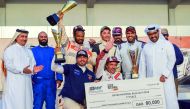 Qatar Baja winners pose with their trophies along with Qatar Motor and Motorcycle Federation (QMMF) President Abdulrahman Al Mannai applauds. RIGHT: Ahmed Allouh displays his trophy after winning the Qatar National Baja title at Losail International Circu