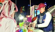 A local kid enjoying his treat from Cane Hut (part of Bedaya Center section) at CTC Festival held at Hotel Park yesterday.