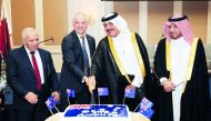 H E Mohamed bin Abdullah Al Rumaihi, Minister of Municipality and Environment (second right) cutting a cake with Dr Axel Wabenhorst (second left), Australian Ambassador to Qatar; and H E Ibrahim Yousif Abdullah Fakhro, Ministry of Foreign Affairs’ Chief o