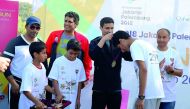 QOC Secretary-General Jassim Al Buenain presenting schoolchildren their medals.