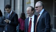 Uber attorney Bill Carmody (R) and Waymo attorney Charles Verhoeven (L) pose for a photo outside of the Phillip Burton Federal Building after the Waymo-Uber technology theft trial was dismissed on February 9, 2018 in San Francisco, California.  Justin Sul