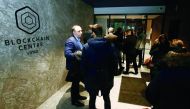 People arrive for a presentation at the blockchain centre, which aims at boosting start-ups, on February 7, 2018 in Lithuania's capital Vilnius.  AFP / Petras Malukas
