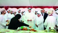 Minister of Economy and Commerce, H E Sheikh Ahmed bin Jassim bin Mohammed Al Thani, visiting a stall after inaugurating the Seasonal Dates Market at Souq Waqif, yesterday.