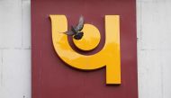 A pigeon flies past the logo of Punjab National Bank outside a branch of the bank in New Delhi, India February 15, 2018. Reuters/Adnan Abidi